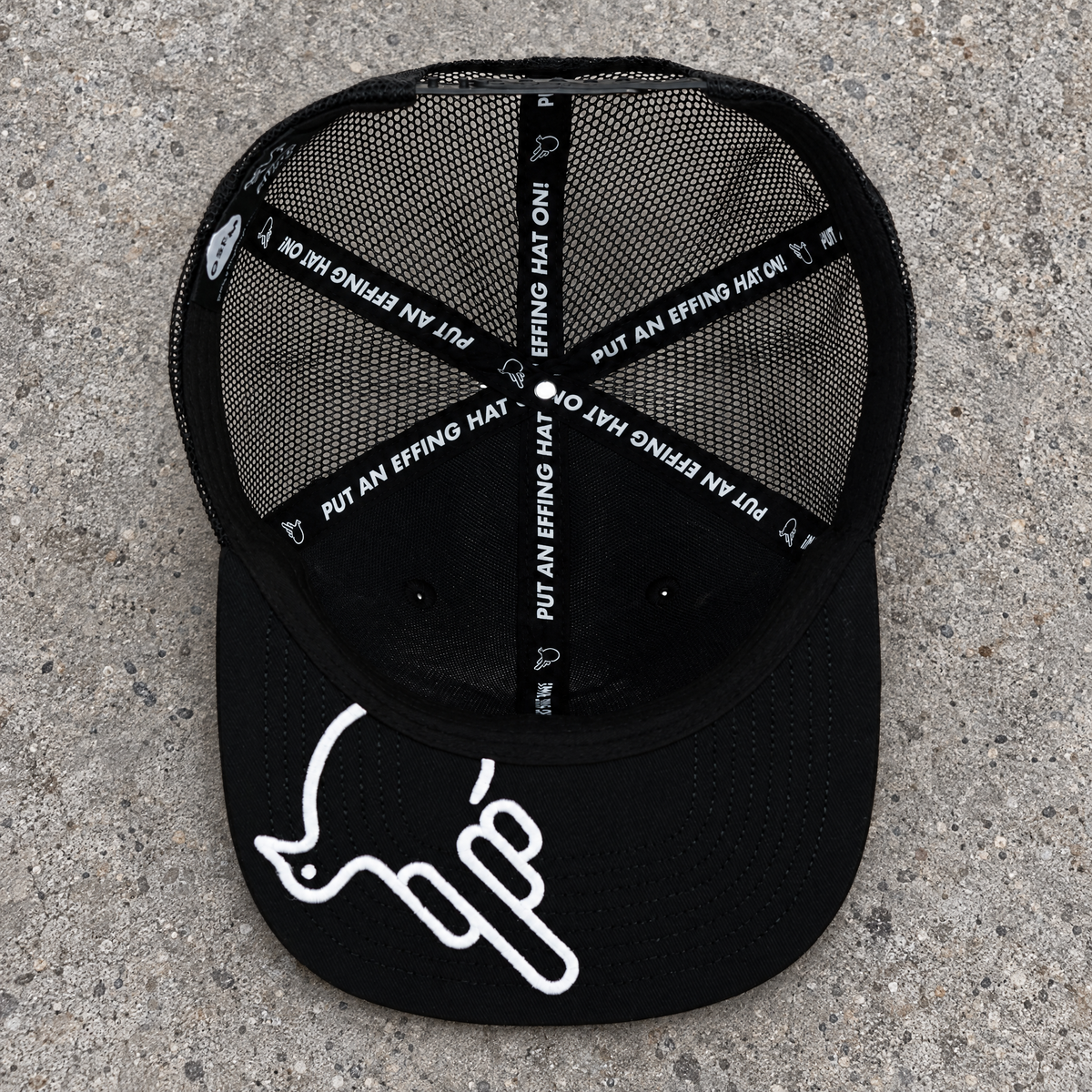 Actual White Bird underside with original white artwork, black mesh and branded seam tapes on concrete.